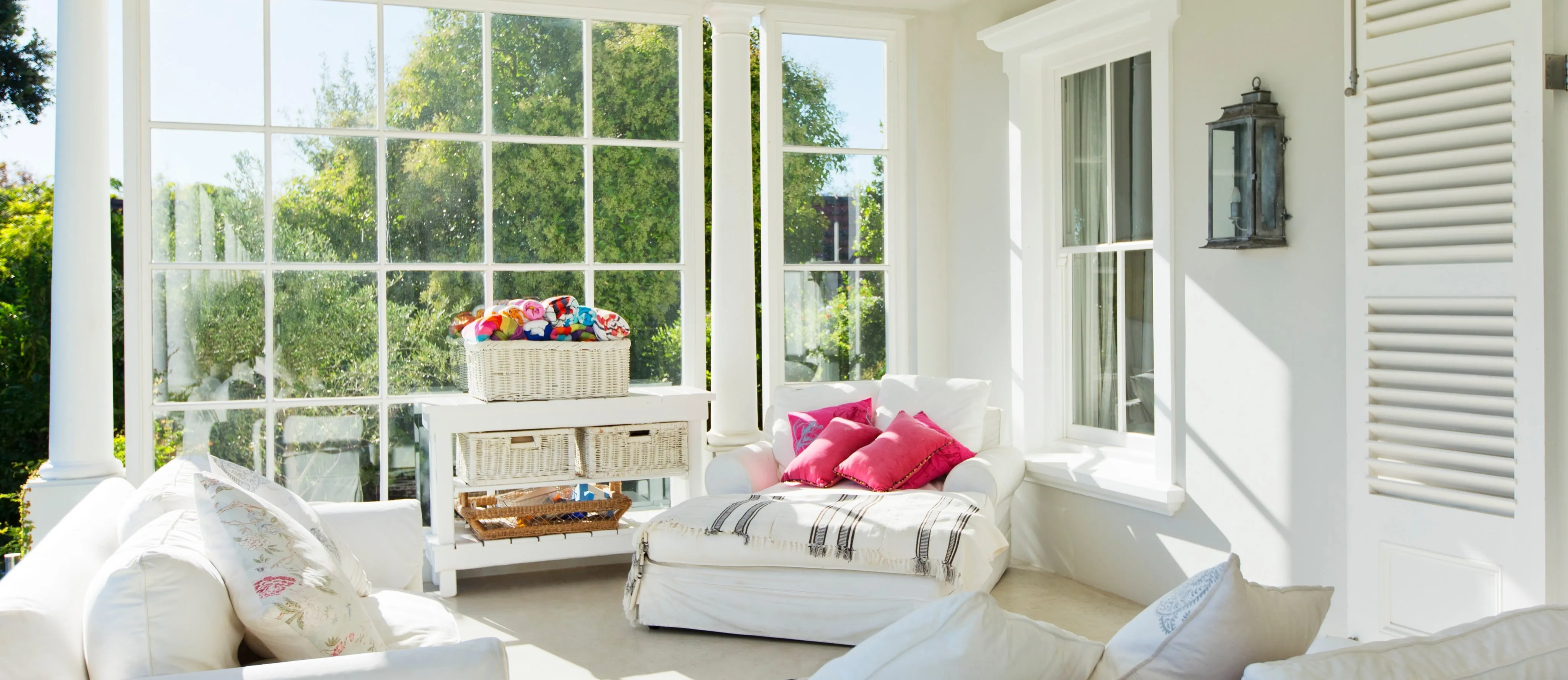 a sunroom that has comfy couches
