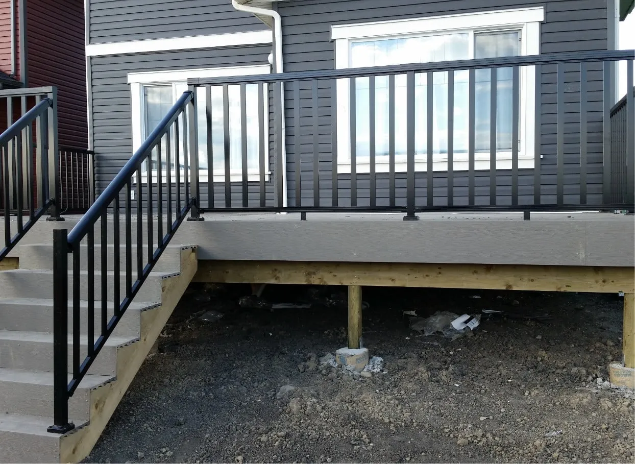 a deck with stairs and a railing